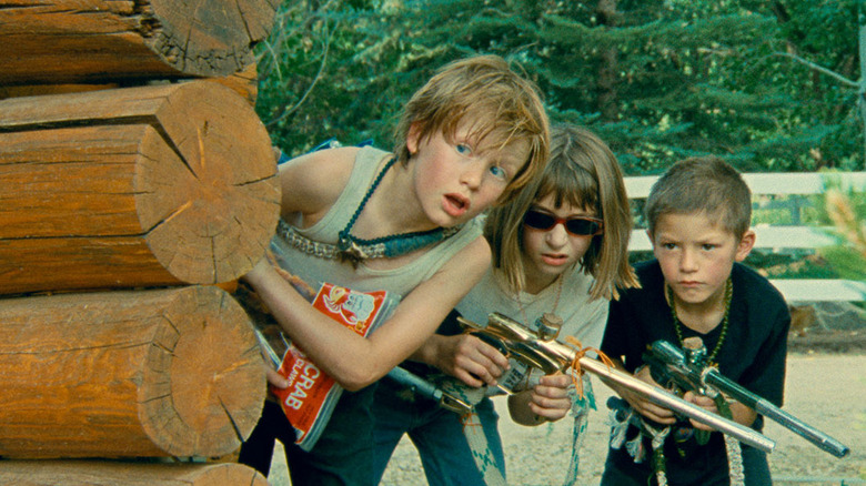 Kids hold paintball guns