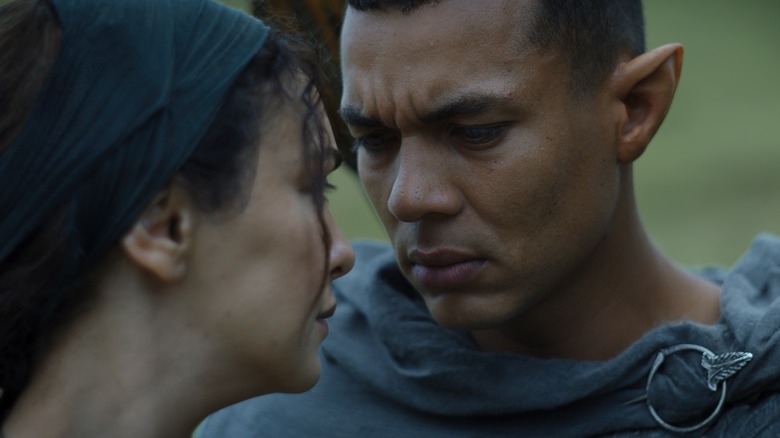 Arondir and Bronwyn looking intensely 