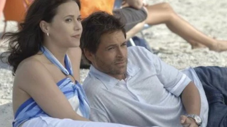 Rob Lowe and Julia Ormand lie on beach