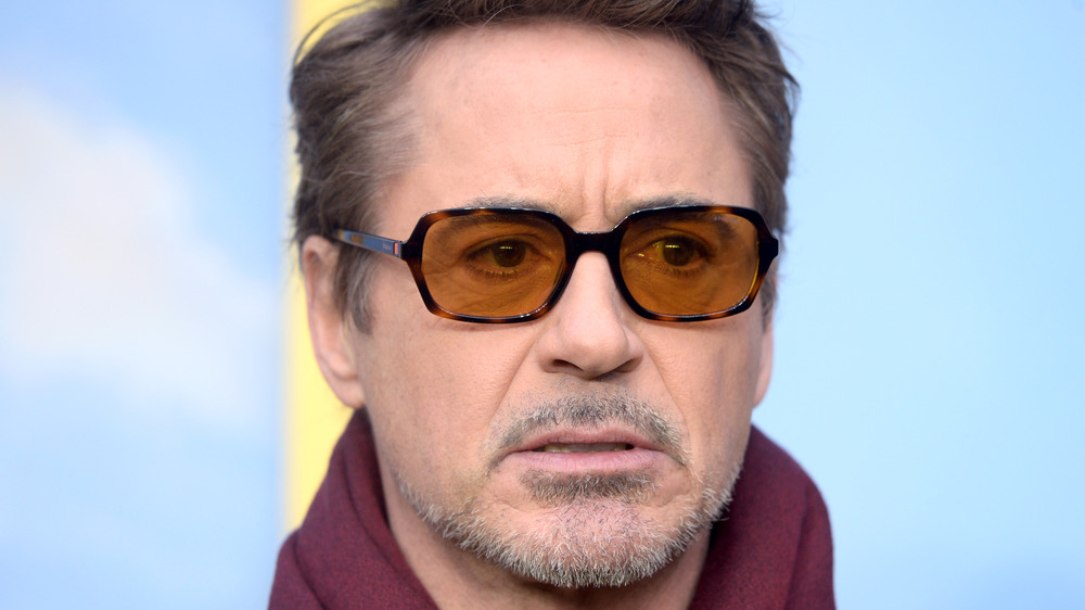 Robert Downey Jr. posing for camera with his signature glasses