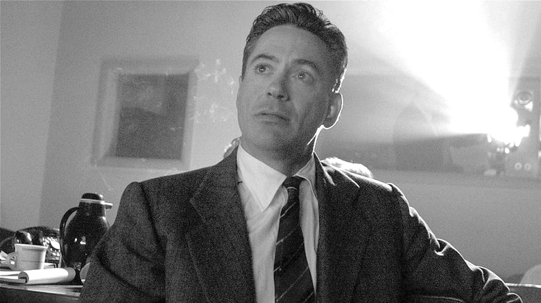 Joseph Wershba sits in front of a film projector in 