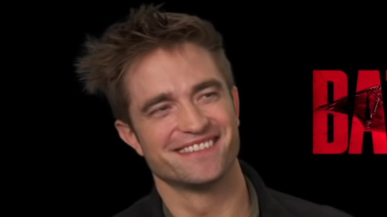 Robert Pattinson cracks a smile