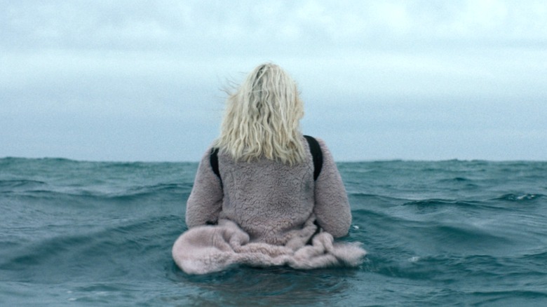 Isla standing in the ocean in "The Discovery."