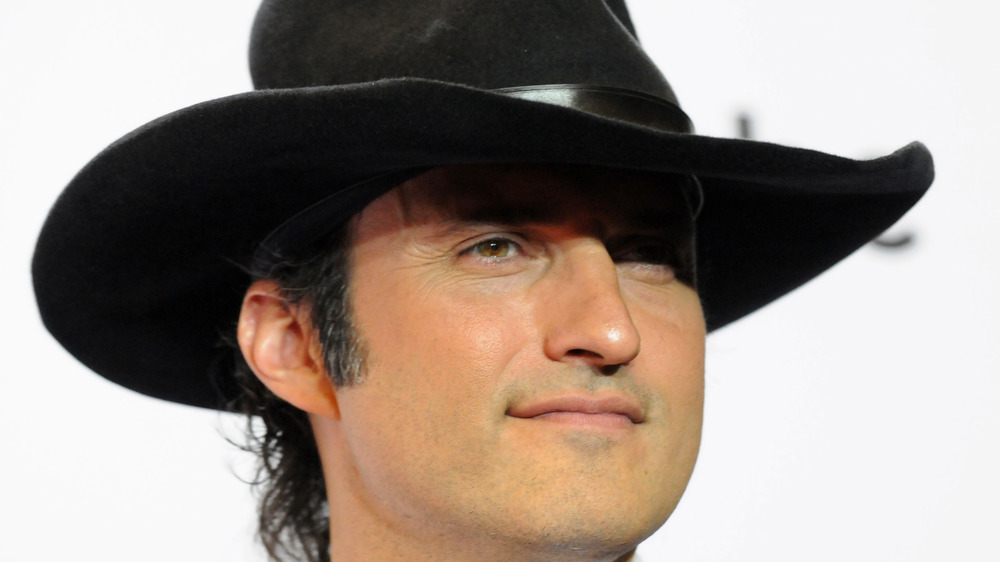 Robert Rodriguez smirking in cowboy hat