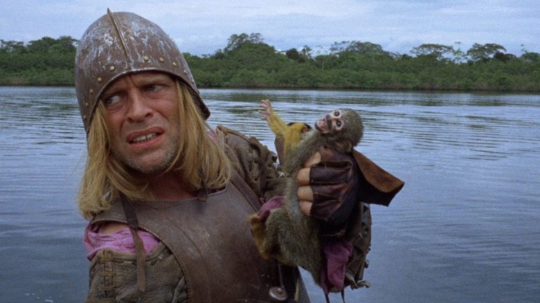 Don Lope de Aguirre emerging from the Amazon holding a monkey in "Aguirre, Wrath of God"