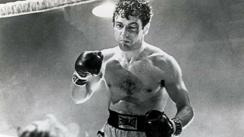 Jake LaMotta standing over a defeated boxer in the ring in "Raging Bull"