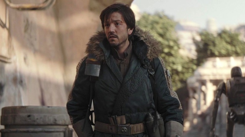 Cassian standing wearing coat