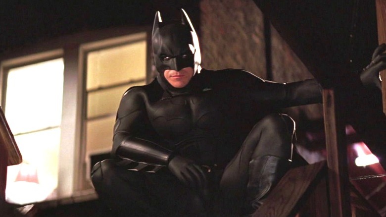 Batman crouching on fire escape