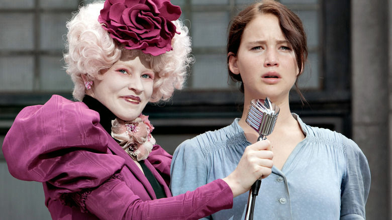 Effie and Katniss standing onstage 
