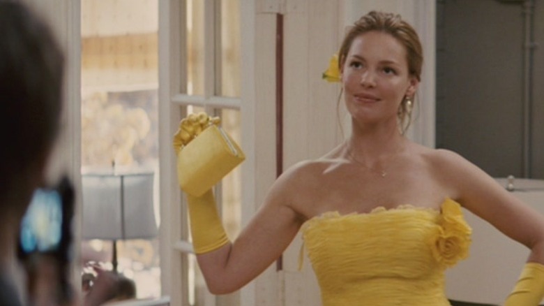 Jane Nichols holding up a yellow purse