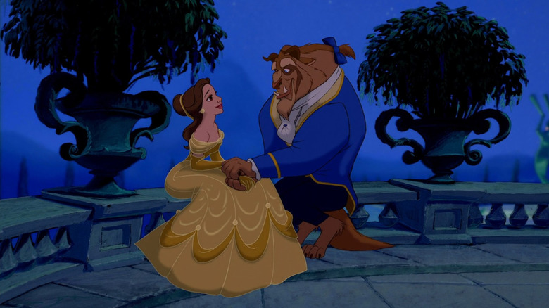 Belle and Beast sit and hold hands in the moonlight in "Beauty and the Beast" (1991)
