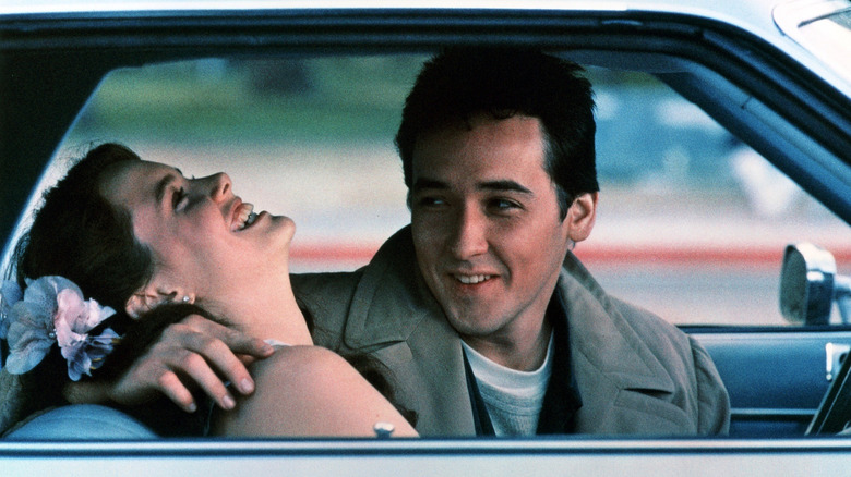 Lloyd with his arm around a laughing Diane in a car in 