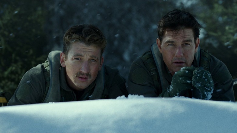 Rooster and Maverick behind snow