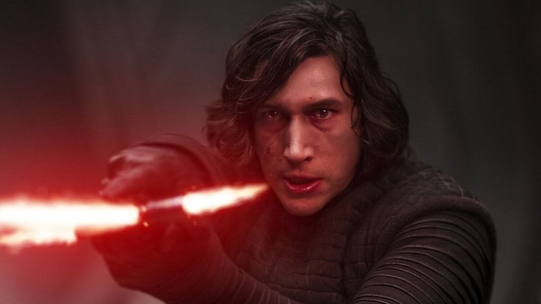 Kylo Ren points lightsaber