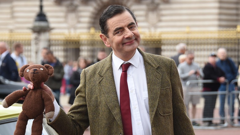 Mr. Bean holding teddy bear