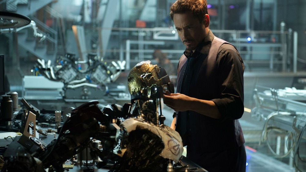 Tony examines robot 