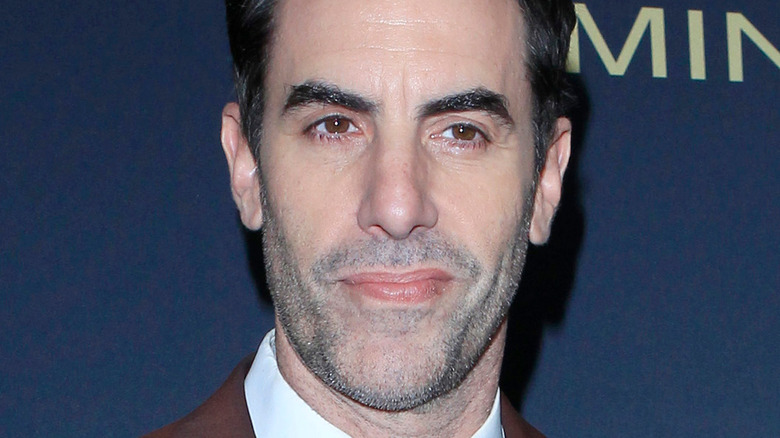 Sacha Baron Cohen smirking