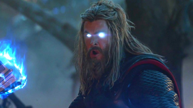 Thor with glowing blue eyes holding Stormbreaker in "Avengers: Endgame" (2019)