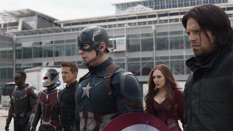 Falcon, Ant-Man, Hawkeye, Captain America, Scarlet Witch, and Bucky Barnes lined up at an airport in "Captain America: Civil War"