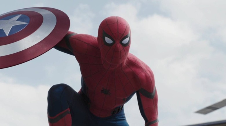 Spider-Man holding Captain America's shield in 