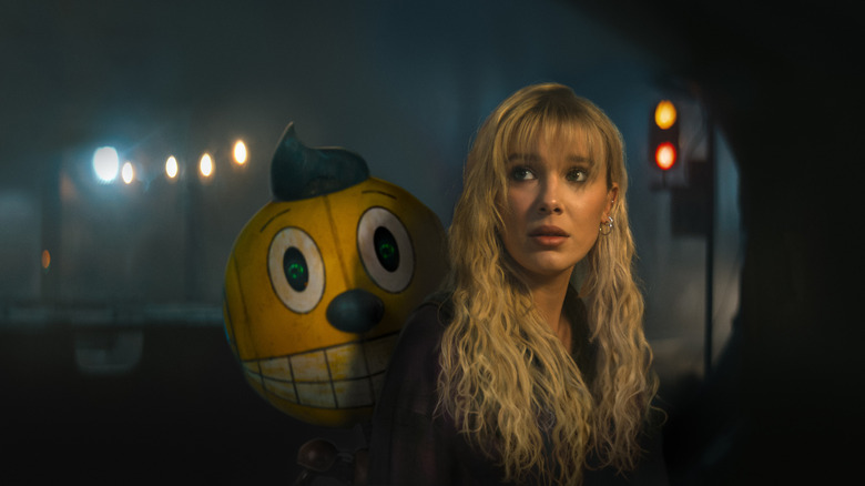 Michelle carrying Cosmo in "The Electric State"