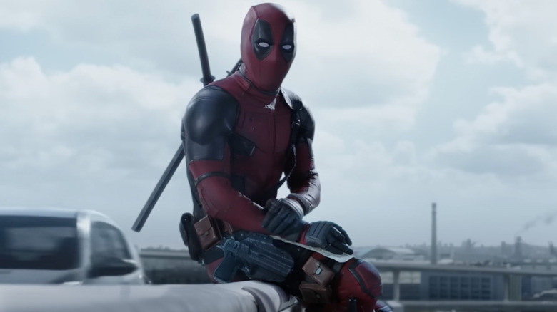 Deadpool sitting on bridge