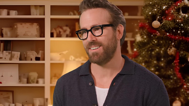 Ryan Reynolds by Christmas tree