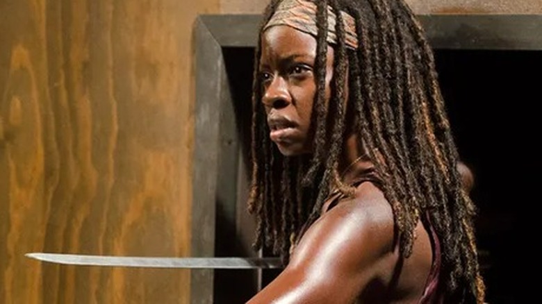 Michonne using her katana to hold off a walker