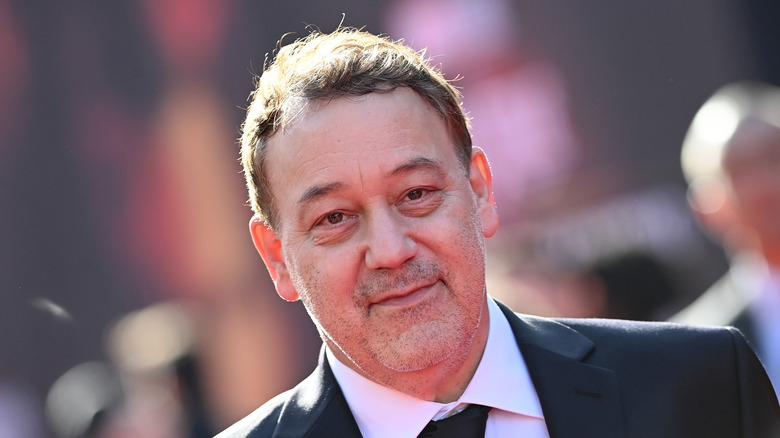 Sam Raimi wearing black suit