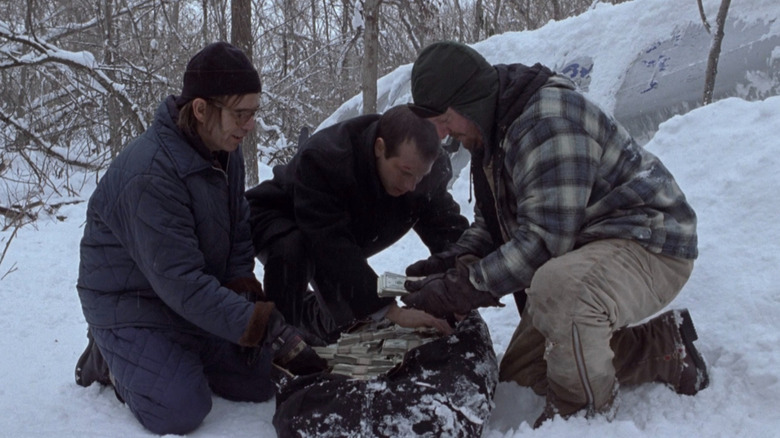 Jacob, Hank and Lou looking through a duffel bag of money in A Simple Plan