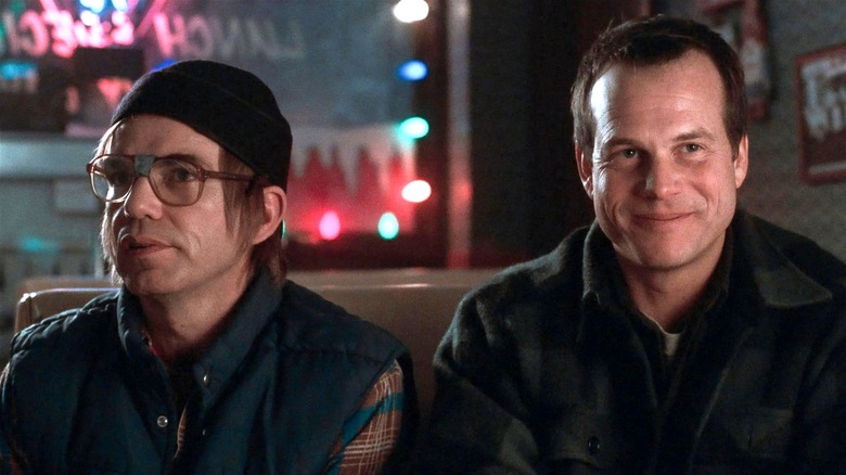 Jacob and Hank Mitchell sitting next to each other in A Simple Plan