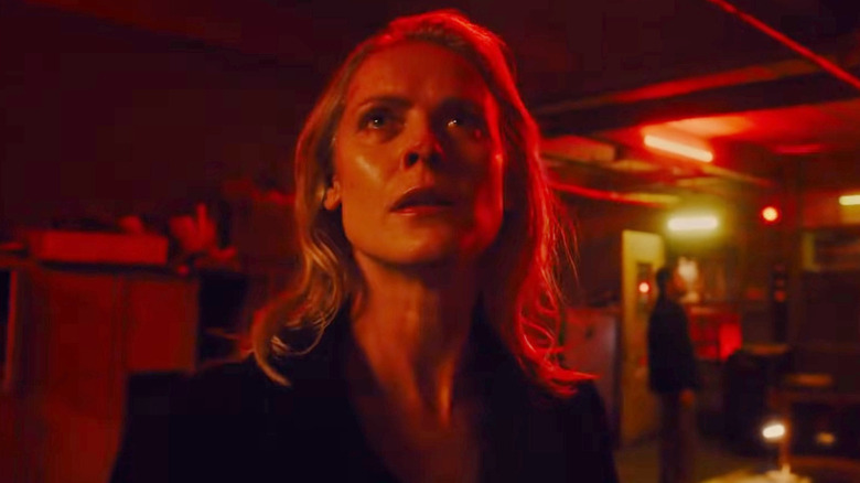 Cecilia Pedersen surprised by the alarms going off in "Saw X" (2023)