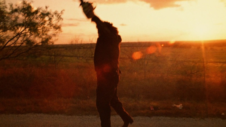 Leatherface swings saw in "The Texas Chain Saw Massacre" (1974)