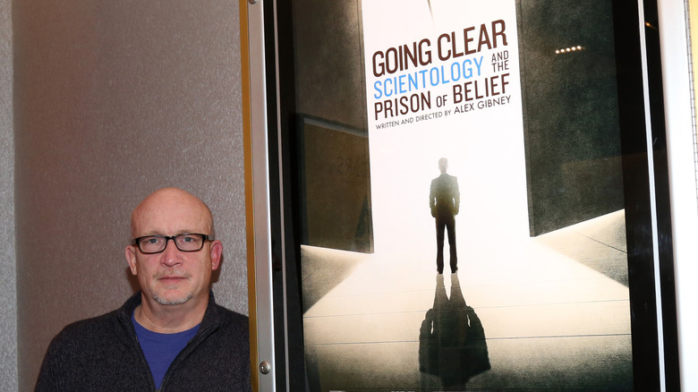 Alex Gibney and "Going Clear" movie poster