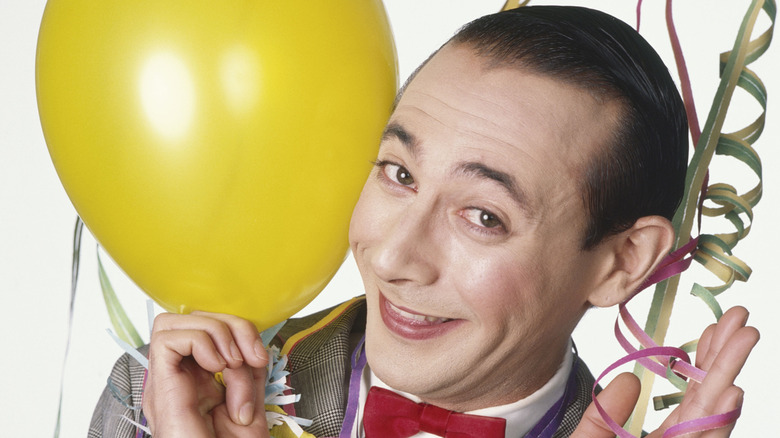 Pee-Wee Herman holding yellow balloon