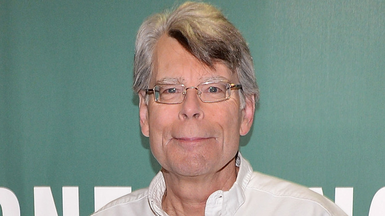 Stephen King holding his book 