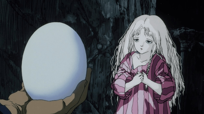 An egg is held in front of a girl in "Angel's Egg" (1985)