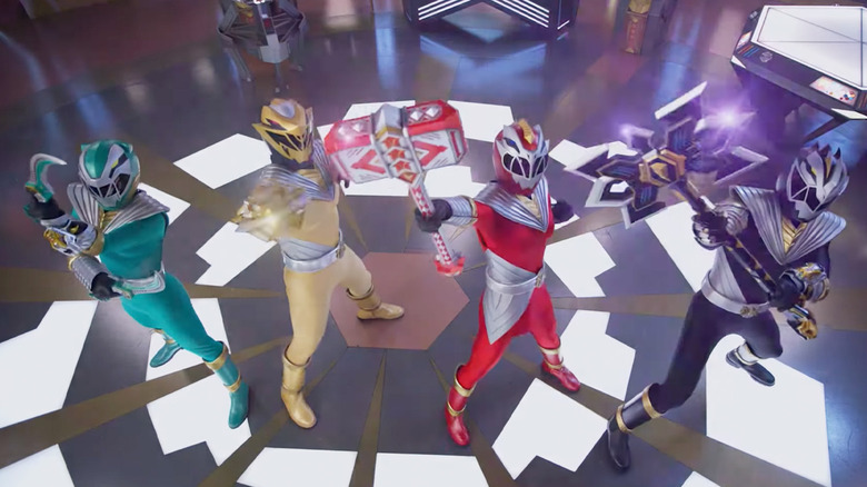 The Power Rangers raise weapons in "Power Rangers: Cosmic Fury" (2023)