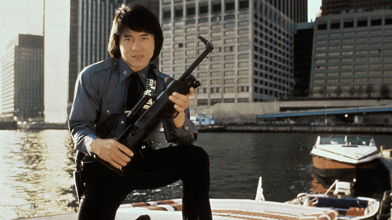 Billy Wong holds a gun on a boat in "The Protector" (1985)