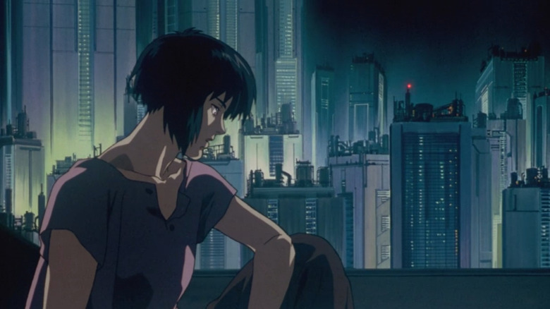 Major Kusanagi sitting in front of a futuristic cityscape in "Ghost in the Shell" (1995)