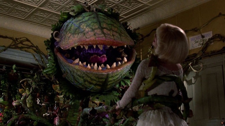 Audrey II holding Audrey in "Little Shop of Horrors" (1986)