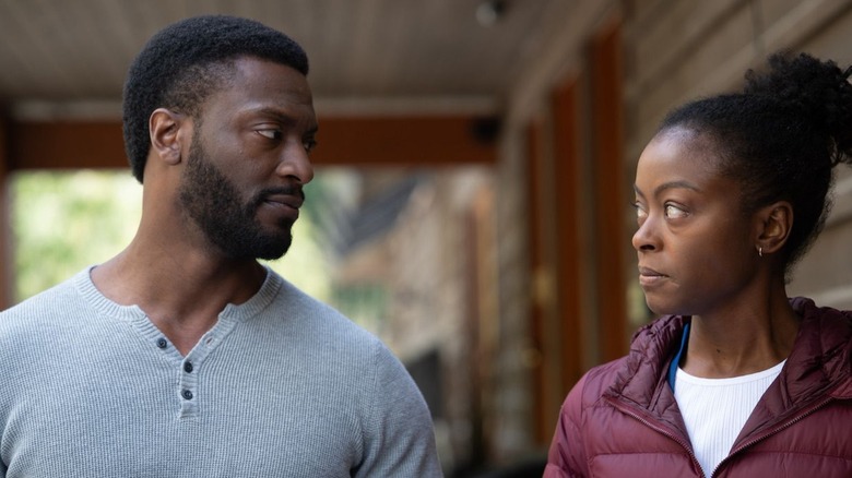 Vanessa and Alex looking at one another in "Parallel" (2024)