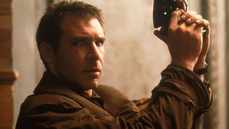 Rick Deckard holding up his firearm in "Blade Runner"