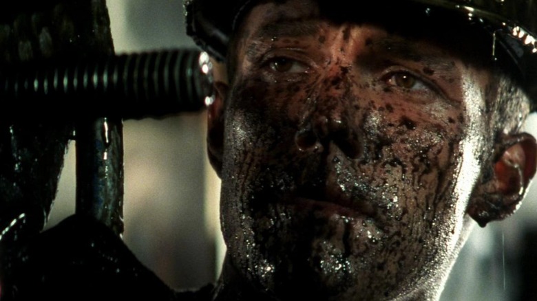 A.J. standing with his face covered in oil in Armageddon (1998)