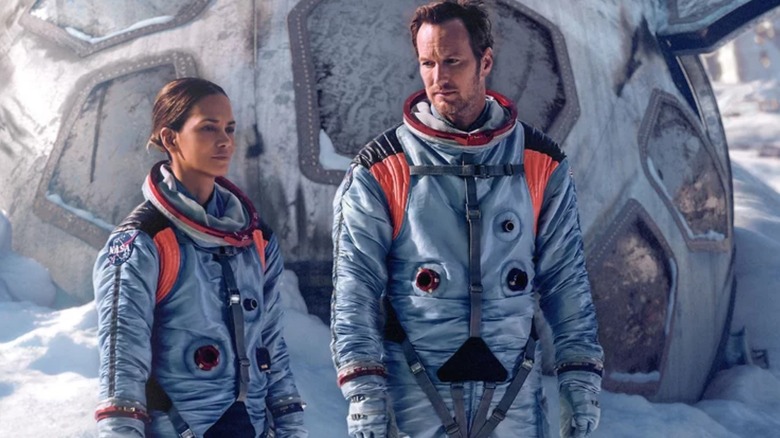 Jocinda and Brian standing beside space shuttle in Moonfall (2022)
