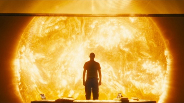 Silhouetted man staring at the sun in Sunshine (2007)