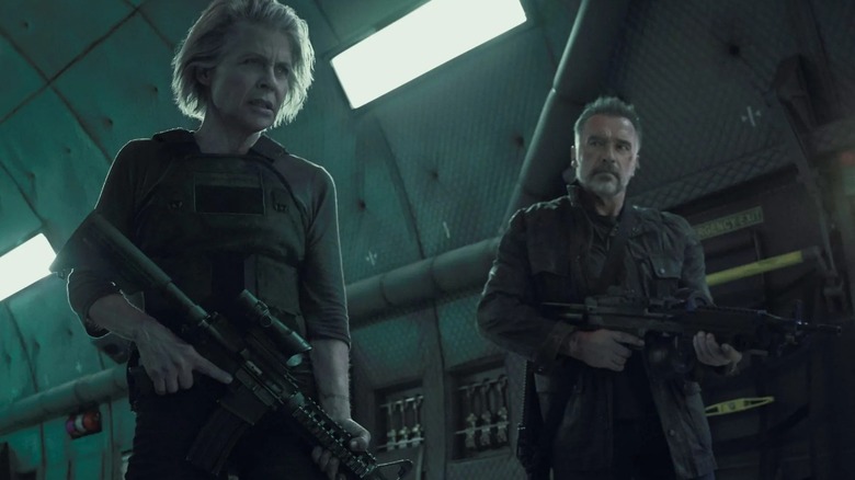 Sarah Connor and the Terminator holding guns in Terminator: Dark Fate (2019)