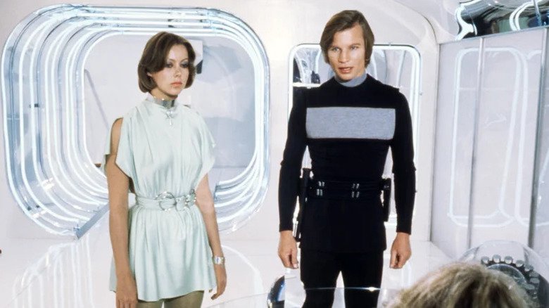 Jessica 6 and Logan 5 in a white futuristic room in Logan's Run