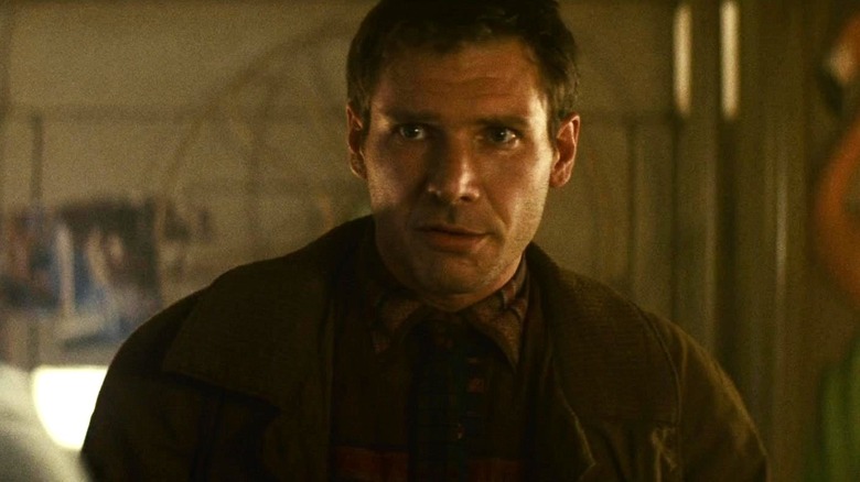 Rick Deckard standing in a room in Blade Runner
