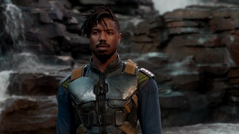 Killmonger standing in front of waterfall